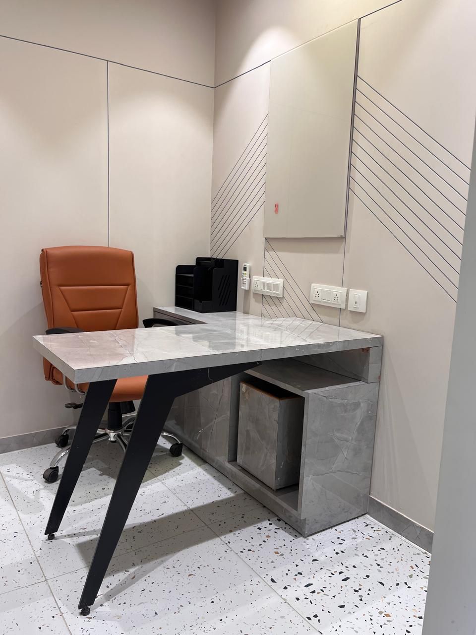 Private office cabin with a marble-top desk