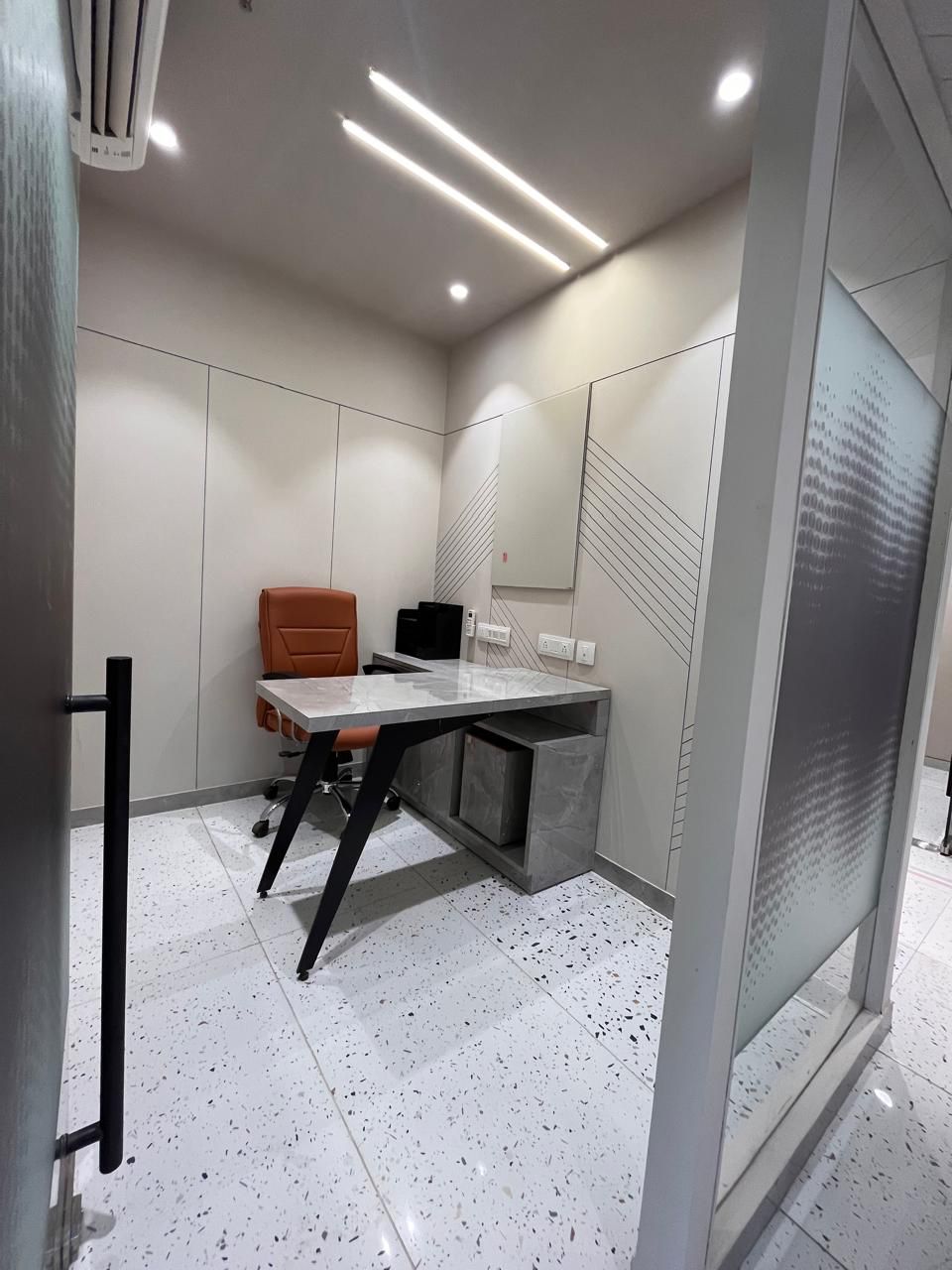 Private office cabin viewed through an open door