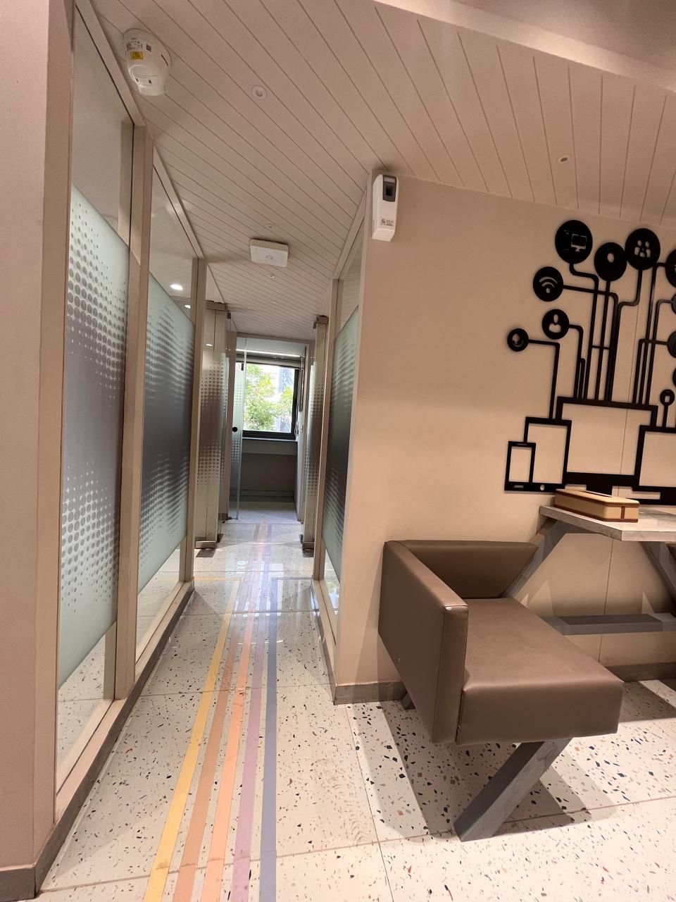 Frosted-glass corridor with colorful floor stripes