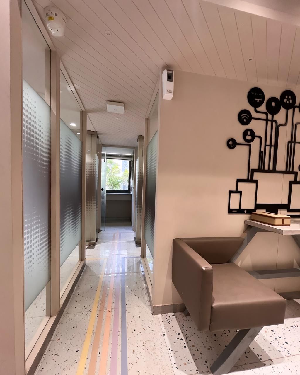 Frosted-glass corridor with colorful floor stripes