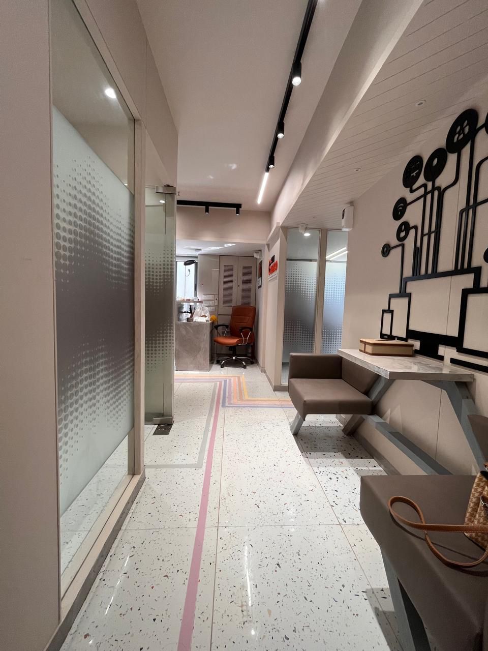 Corridor leading toward the reception desk and lounge seating