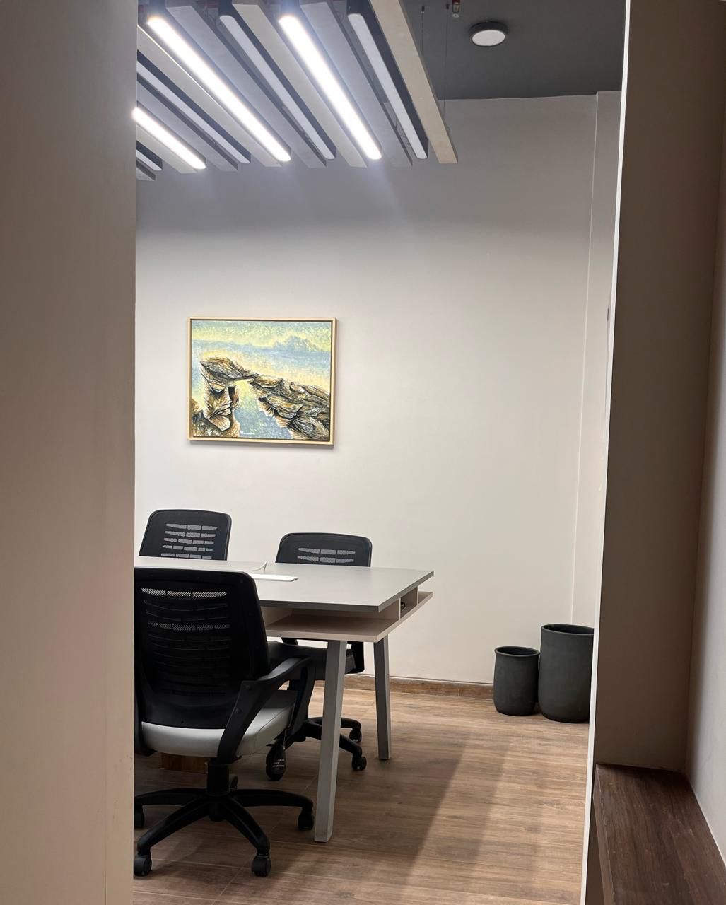 Meeting room with a round table and framed artwork